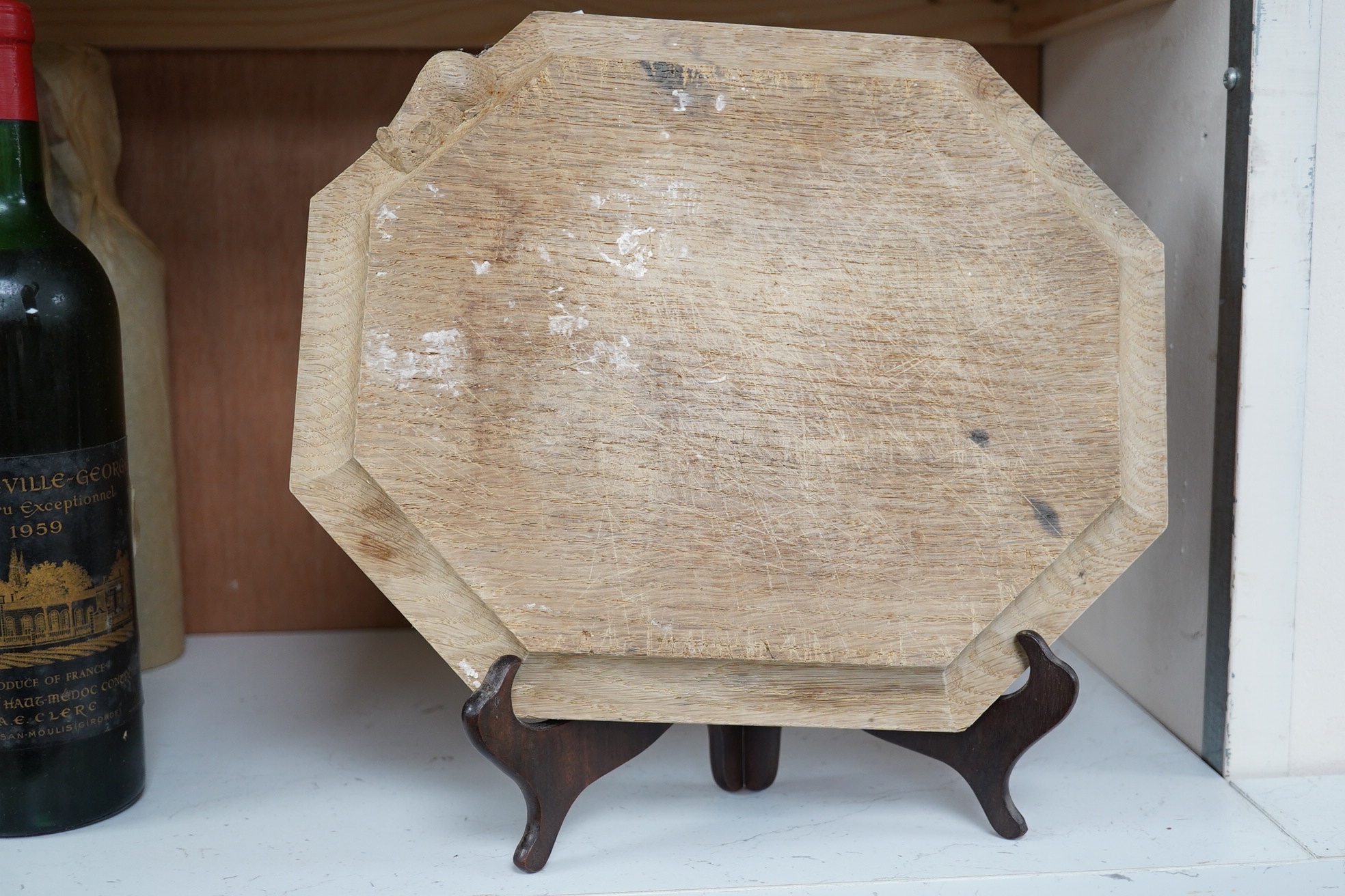 A Mouseman carved oak octagonal bread board, 30cm wide x 25cm deep. Condition - faded and scored